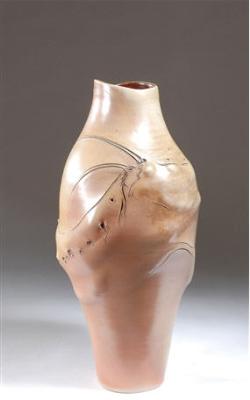 A vase with incised and pierced fish, seaweed and shell forms